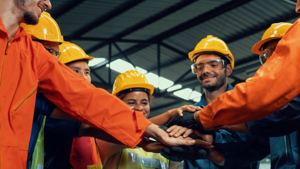 Skillful worker stand together showing teamwork in the factory
